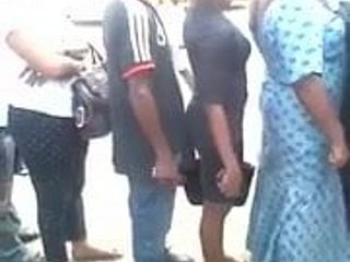Pervert presses his erect dick against a lady's backside